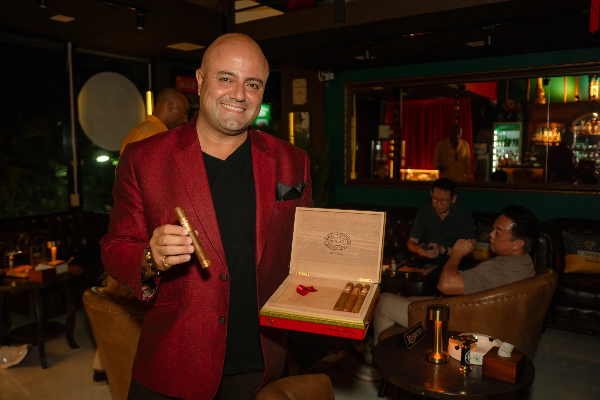 CMLocals Chiang Mai Locals CNX Cigars founder in red blazer holding cigar box Nimman Chiang Mai